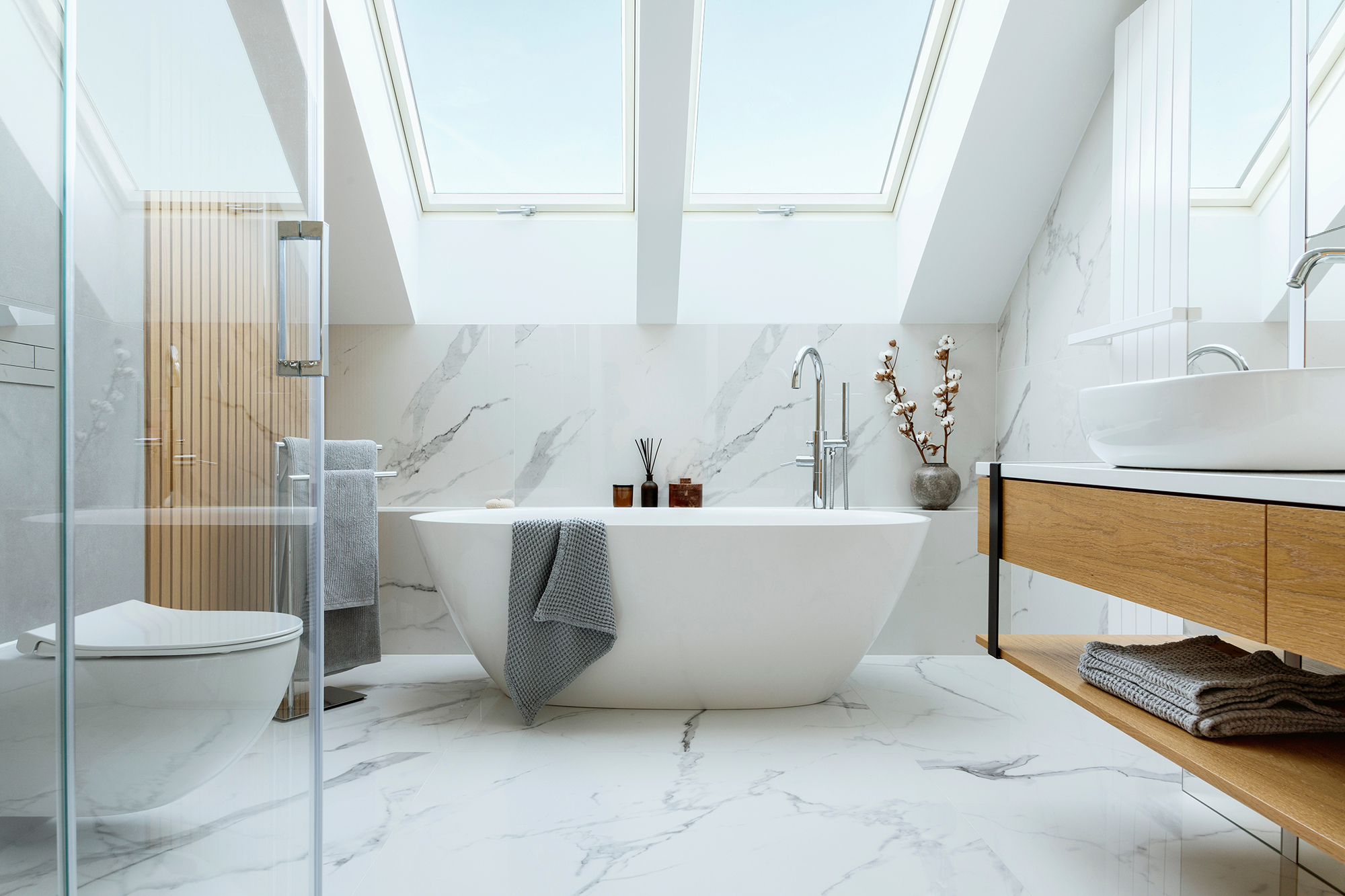 Stylish bathroom interior design with marble panels. Bathtub, towels and other personal bathroom accessories. Modern glamour interior concept. Roof window. Template.